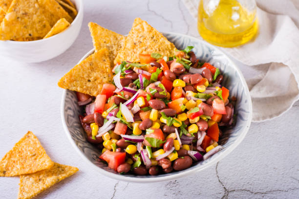 Homemade cowboy caviar traditional mexican vegetable salad and nachos in a bowl on the table