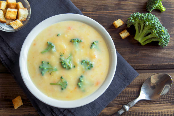 Vegetable and cheese cream soup with broccoli and croutons over wooden background with copy space - homemade healthy organic vegetarian vegan diet fresh food meal dish soup lunch